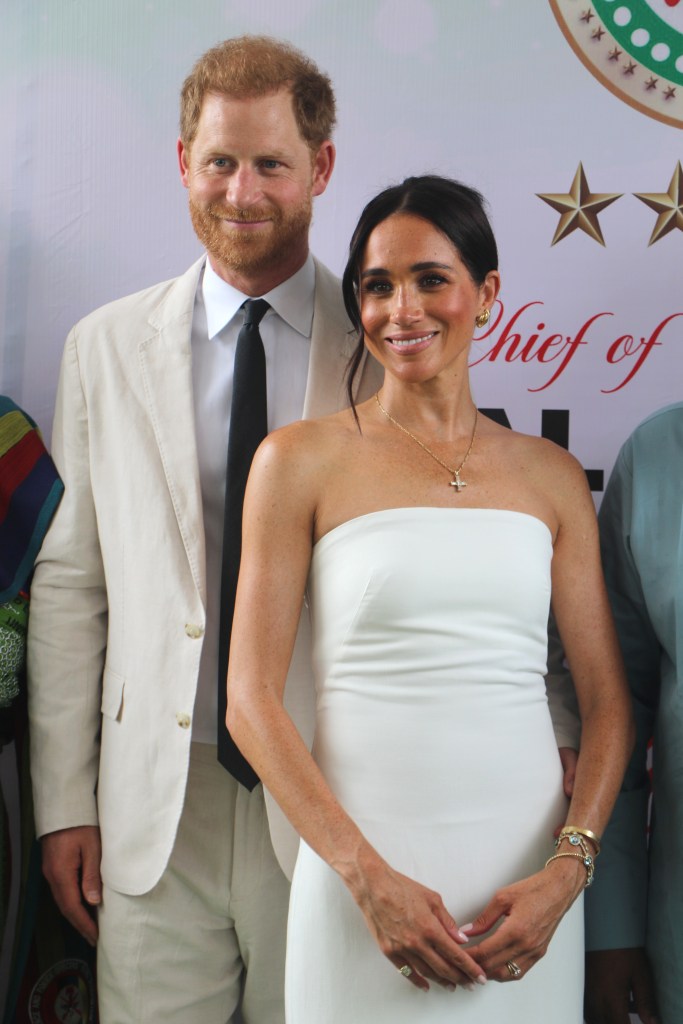 Prince Harry and Meghan Markle pose for a photo as they attend the program held in the Armed Forces Complex in Abuja, Nigeria on May 11, 2024.