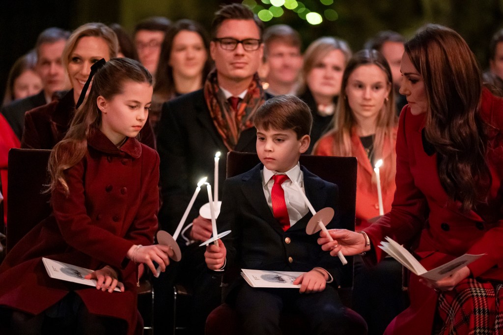 Kate Middleton lights candles with Princess Charlotte and Prince Louis.