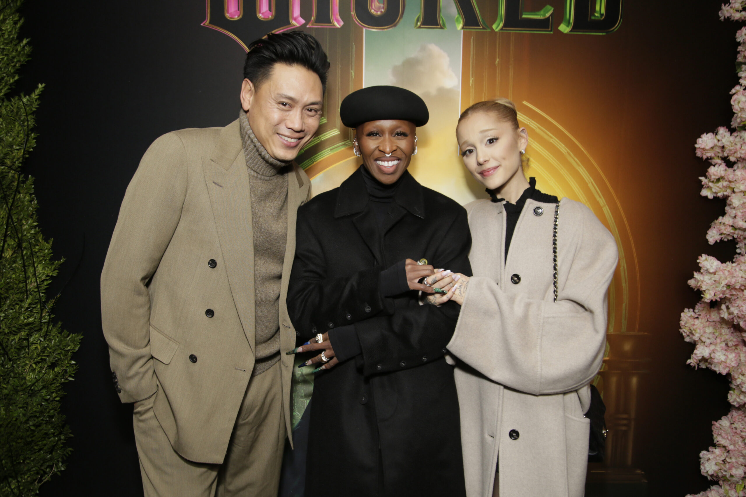 Jon M. Chu, Ariana Grande and Cynthia Erivo posing together