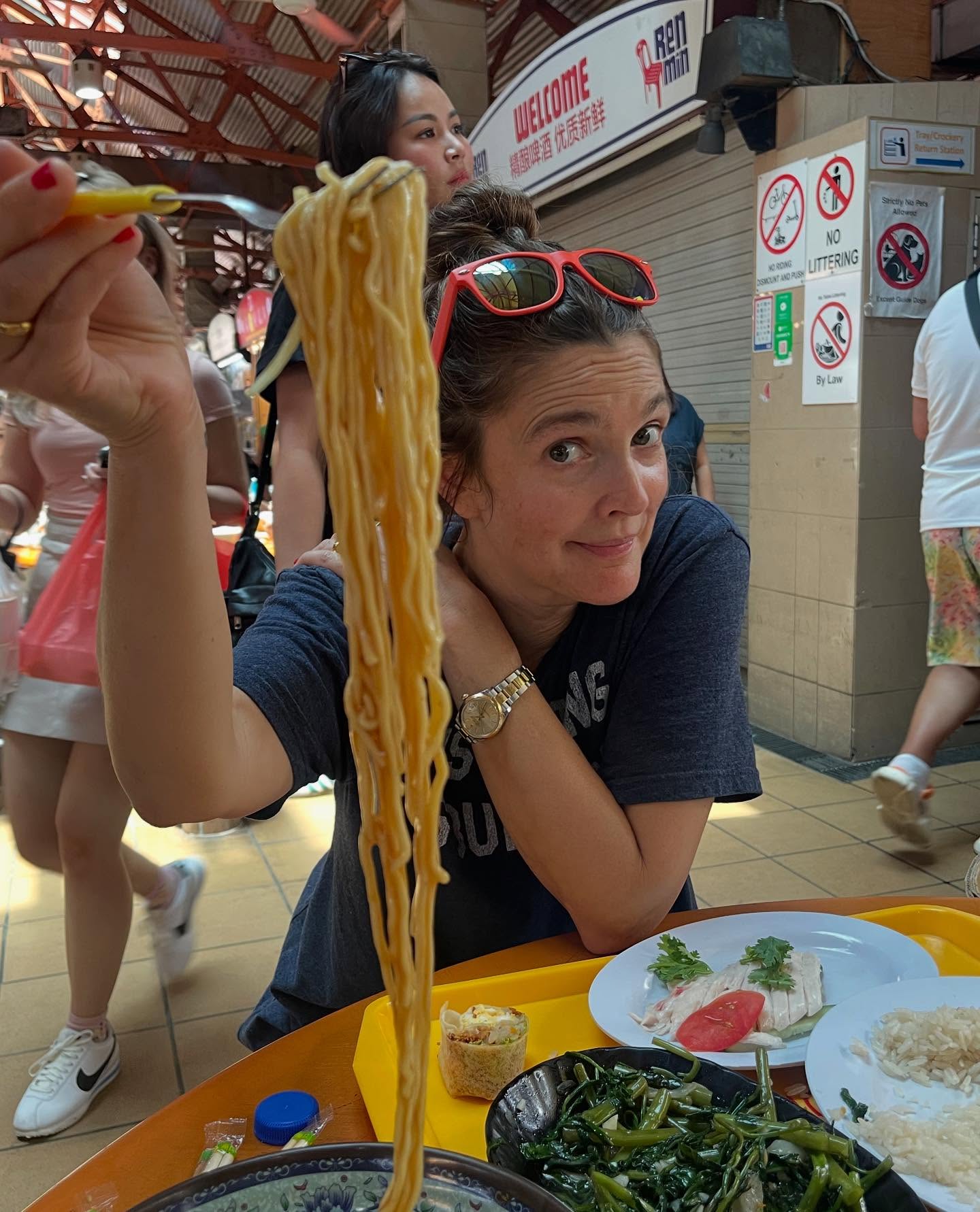 Drew Barrymore immerses herself in the local cuisine in Singapore.