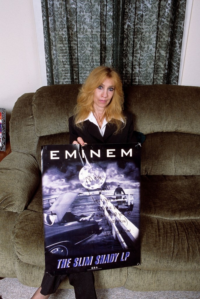 Eminem's mother Debbie Mathers holds a poster with a hand written message during a portrait session at her home in September, 2005 in Detroit, Michigan.