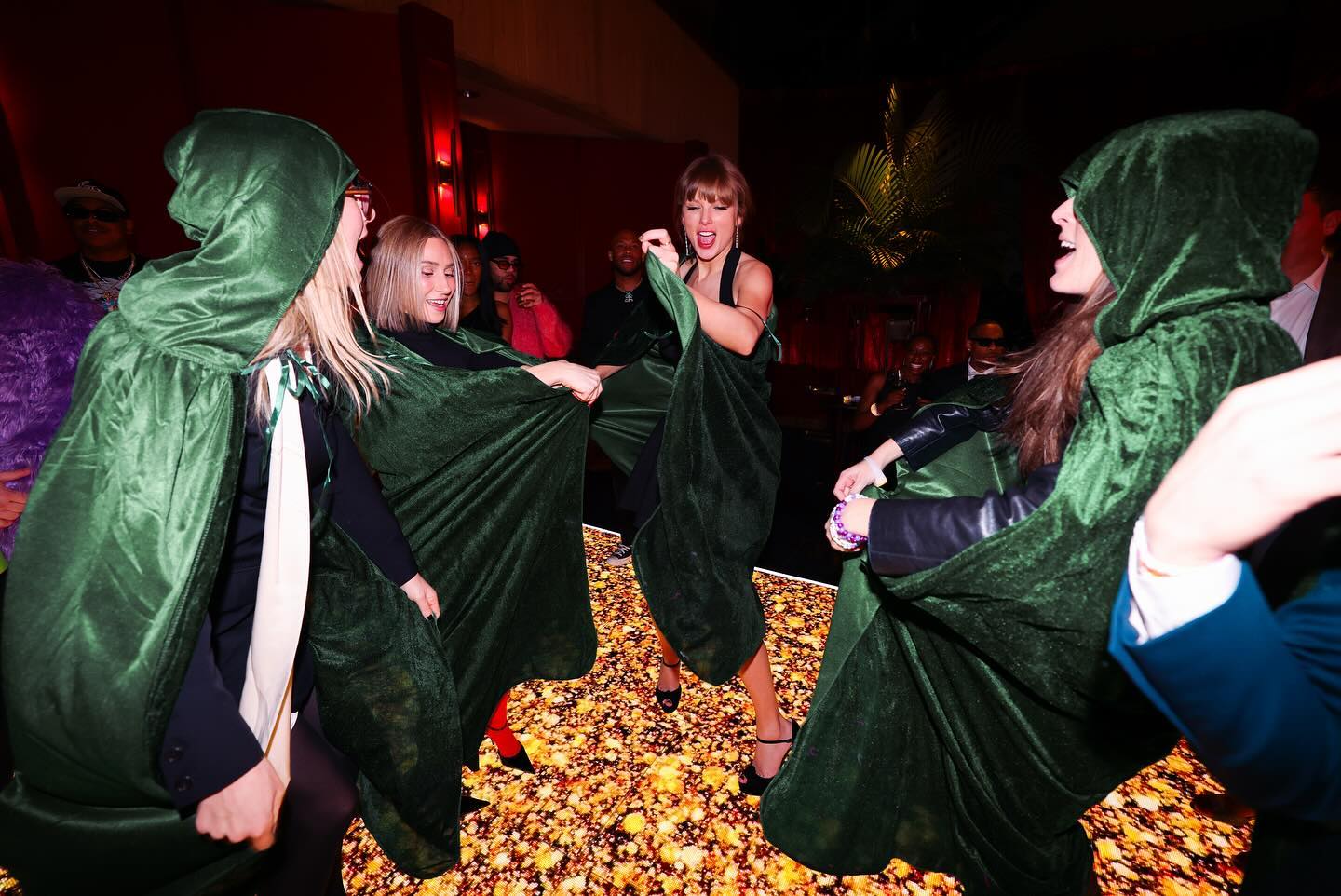 Taylor Swift dancing with friends at the Eras Tour wrap party.