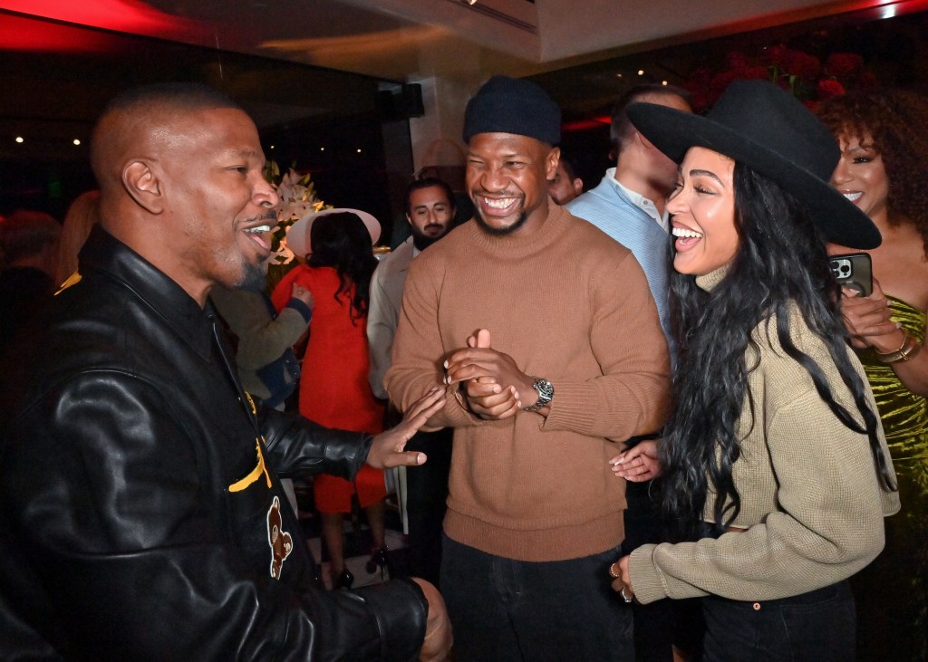 Jamie Foxx, Meagan Good and Jonathan Majors chatting at Mr. Chow.