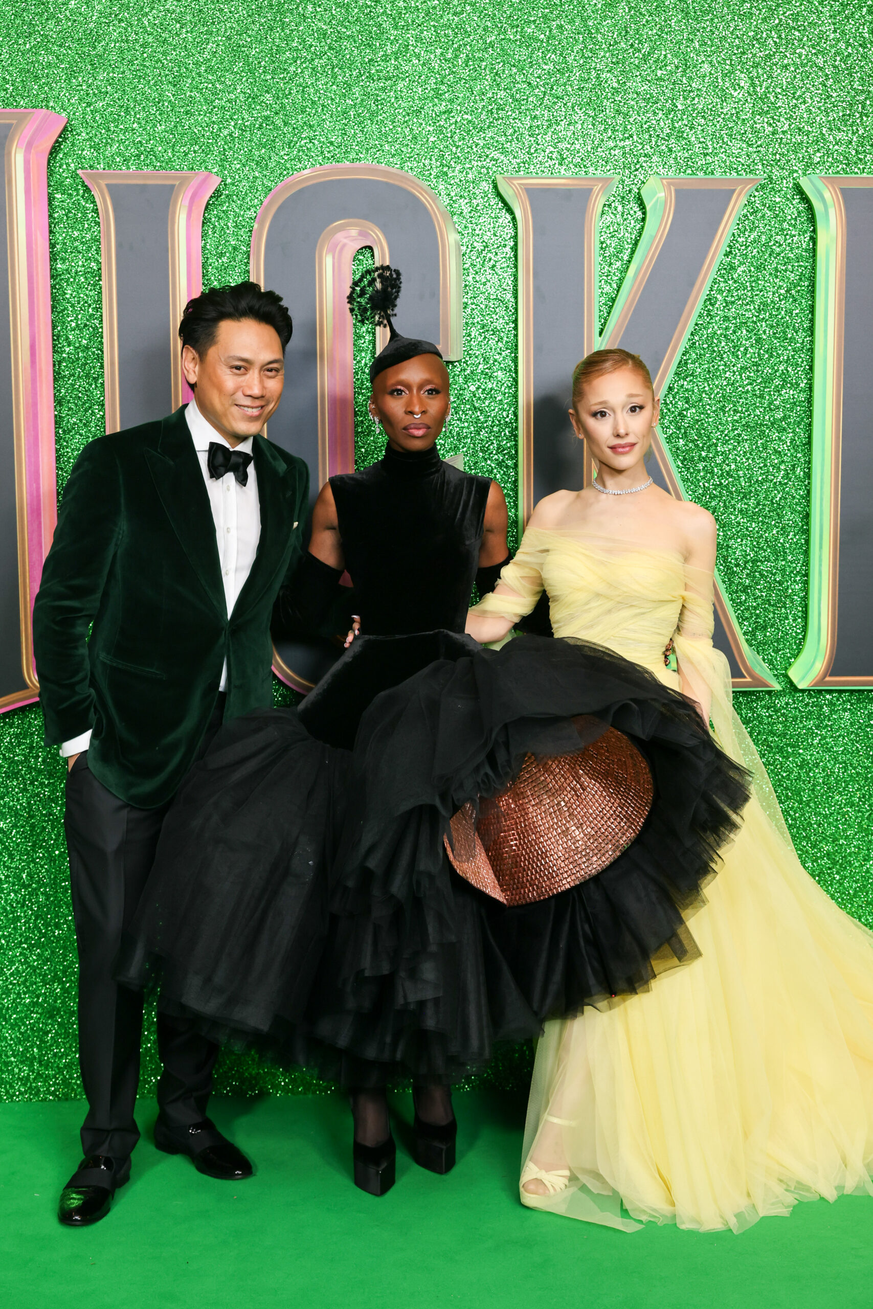 Jon M. Chu, Cynthia Erivo and Ariana Grande posing for a photo