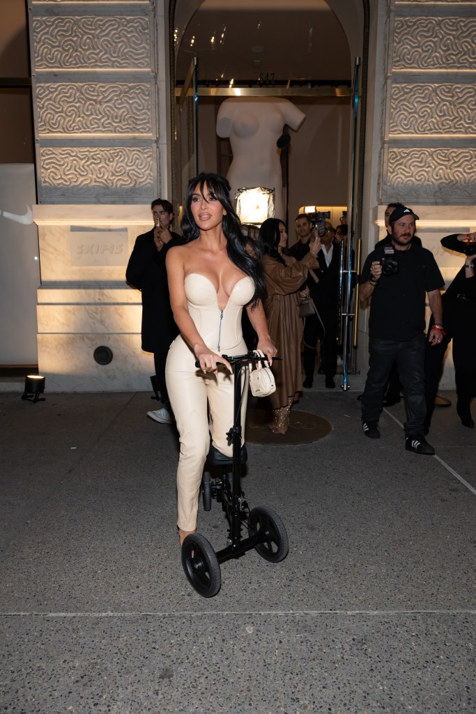 Kim Kardashian on knee scooter at Skims party