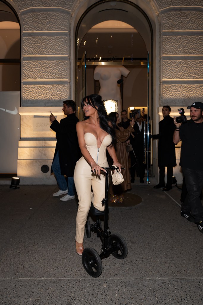 Kim Kardashian on knee scooter at Skims party