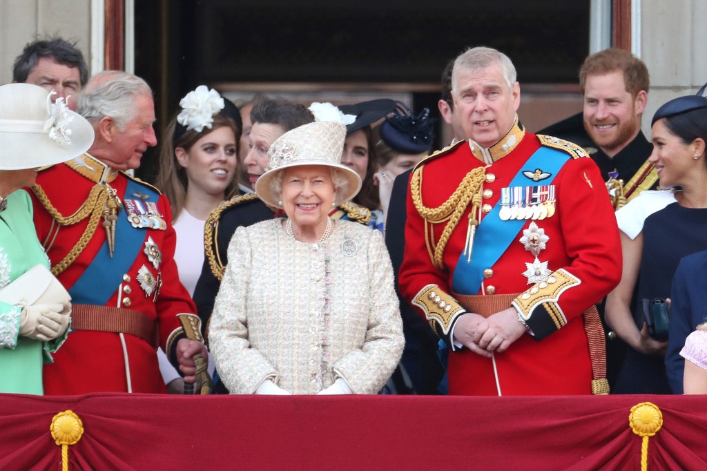 Prince Andrew, Queen Elizabeth, Prince Harry, Meghan Markle, King Charles, Princess Anne, and Princess Beatrice on the balcony at Buckingham Palace.