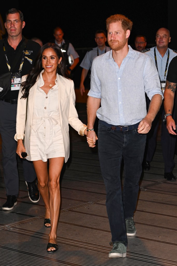 Meghan Markle and Prince Harry walk to a volleyball tournament together.