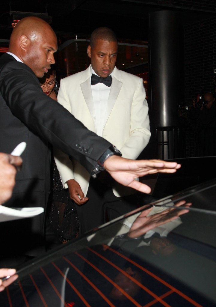 Jay-Z wears a white tuxedo.