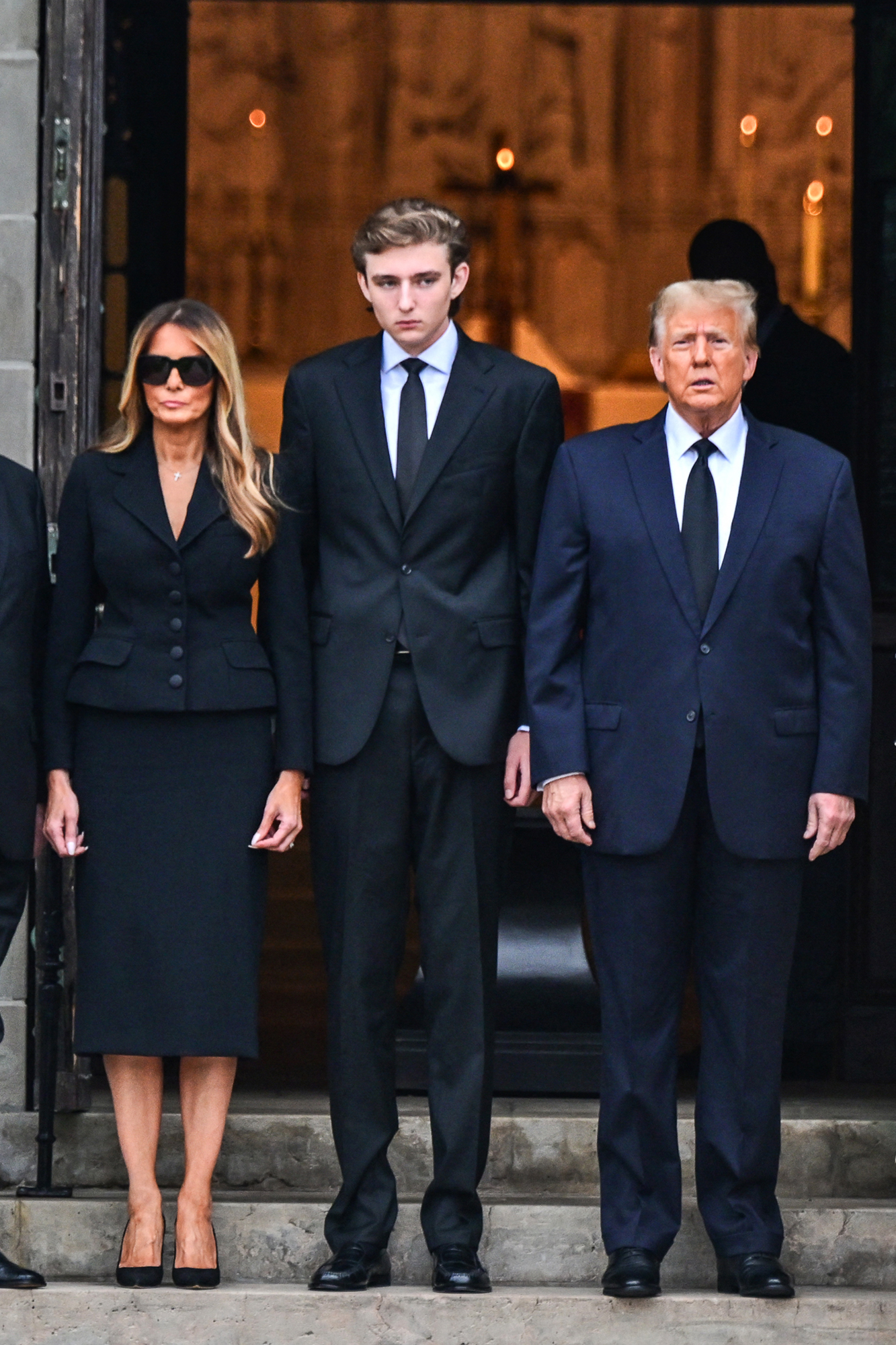 Donald Trump, Melania Trump and Barron Trump at the funeral for Amalija Knavs in 2024.