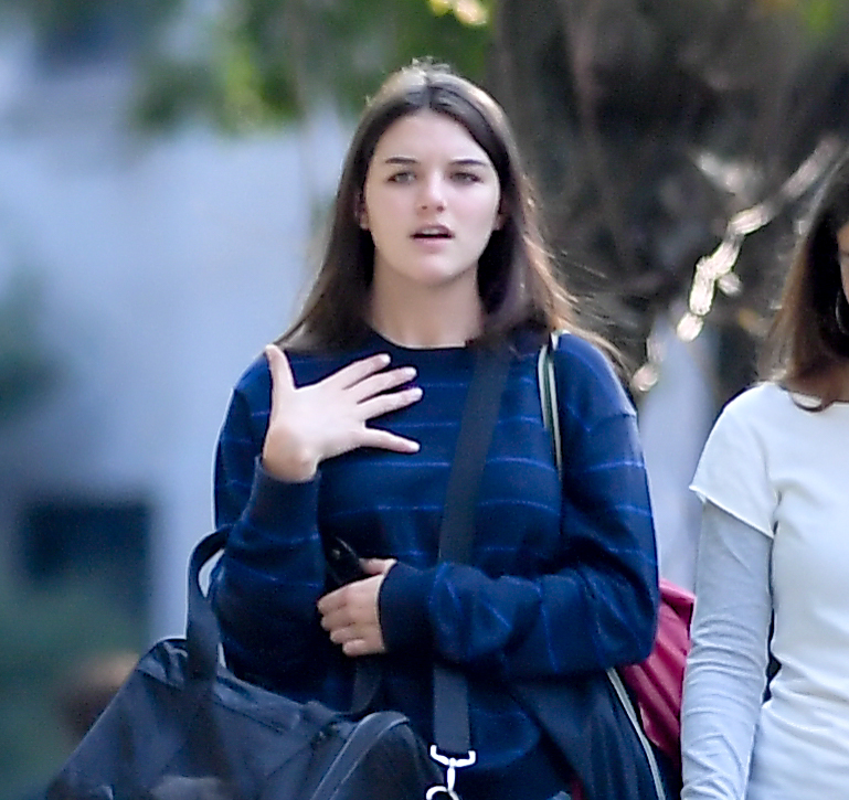 Suri Cruise carries her mother's cat Eleanor while walking with a friend in New York City.