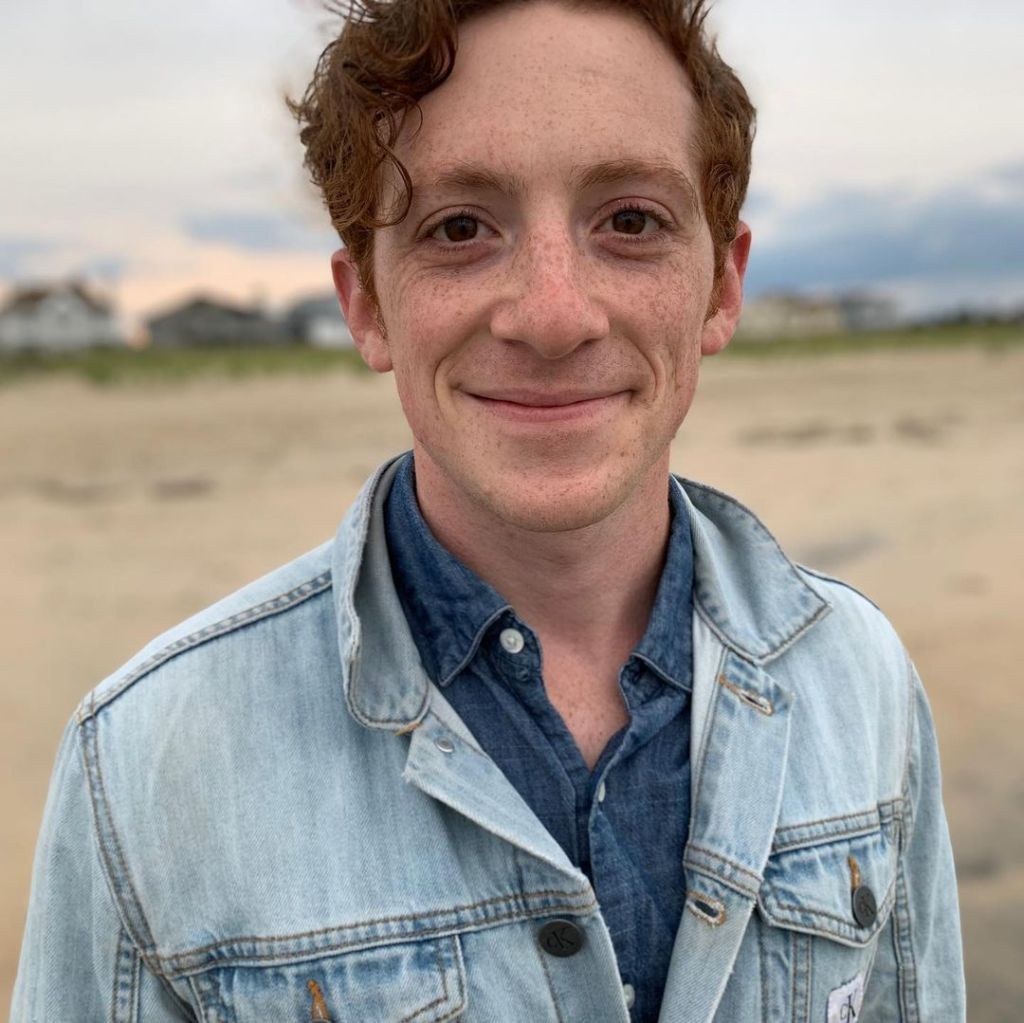 Ethan Slater on the beach.