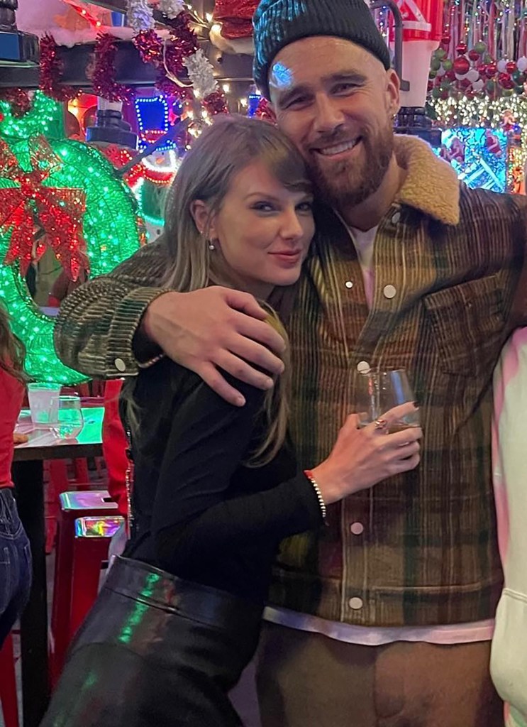 Taylor Swift and Travis Kelce hugging.