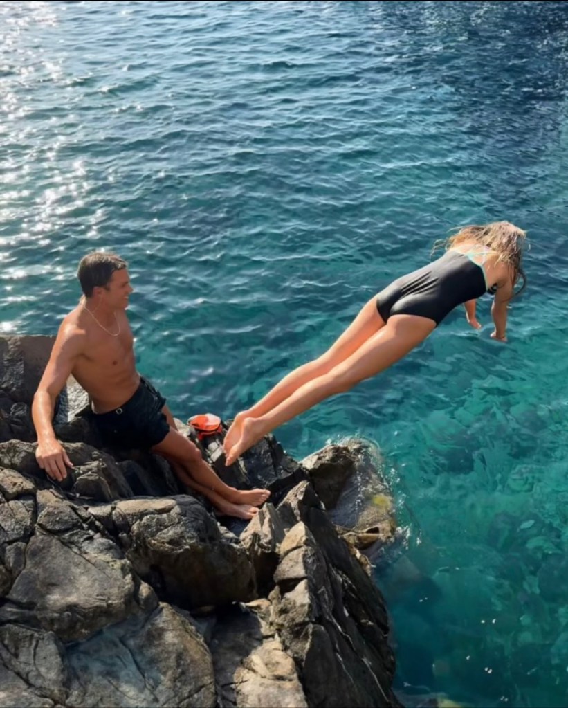 Tom Brady and his daughter Vivian diving off a cliff.