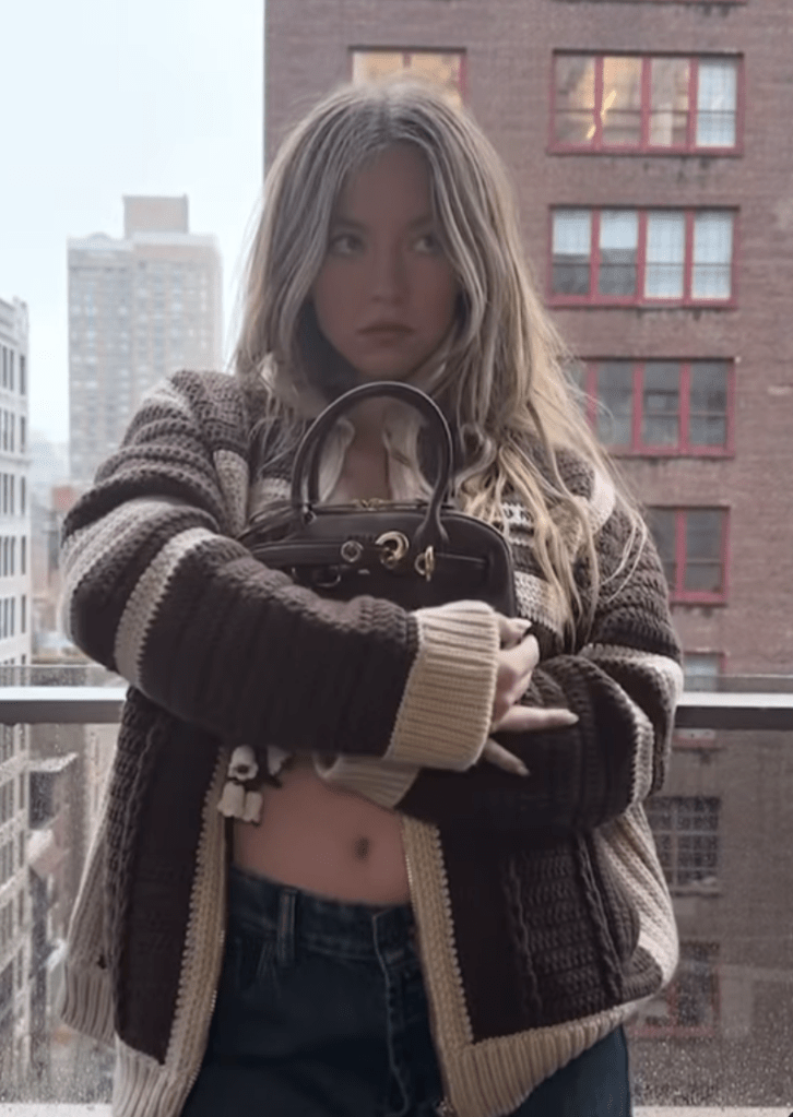 Sydney Sweeney in a brown cardigan