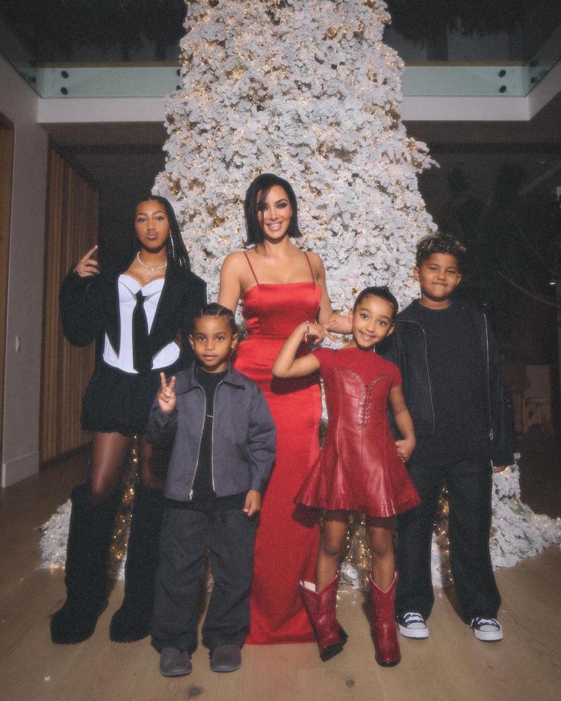 Kim Kardashian and kids in front of christmas tree