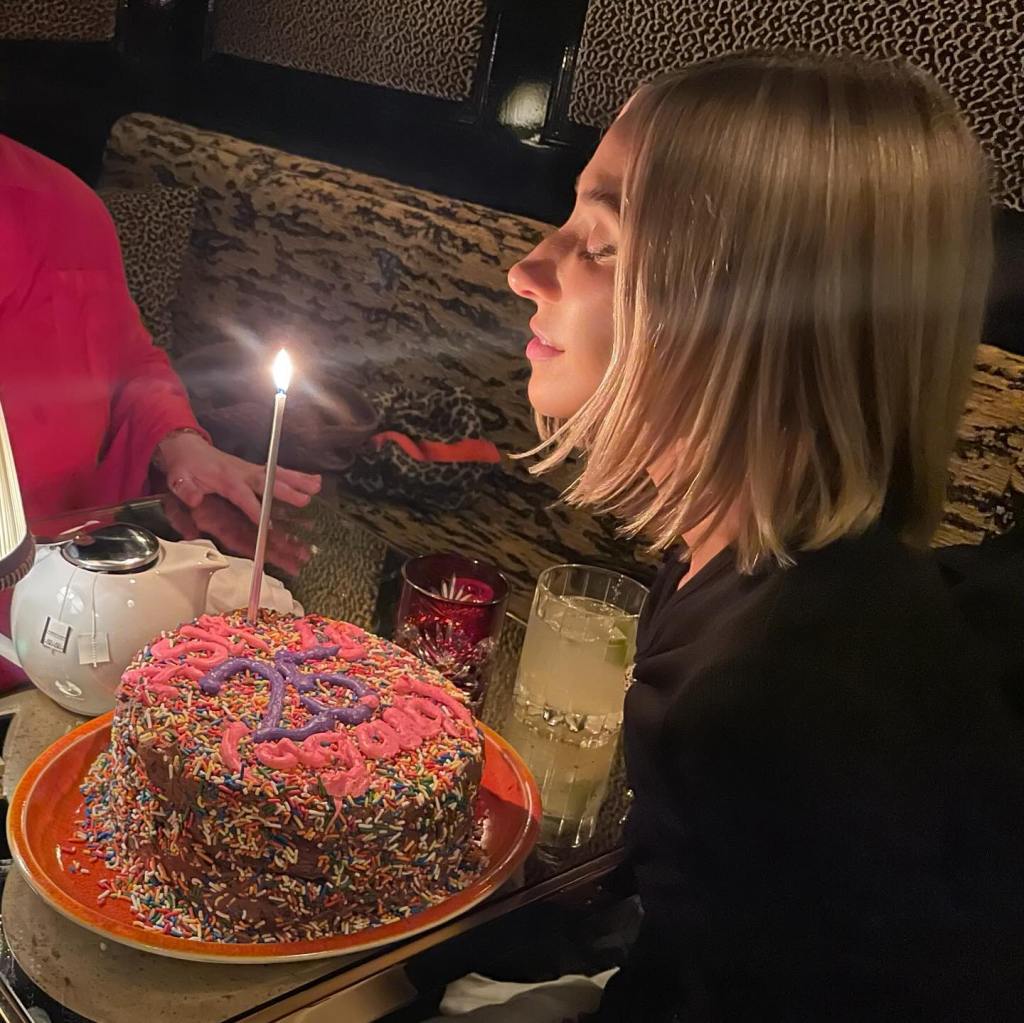 Ashley Avignone blowing out candles.