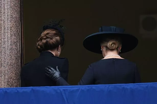 Sophie comforts Kate as he head inside after the service