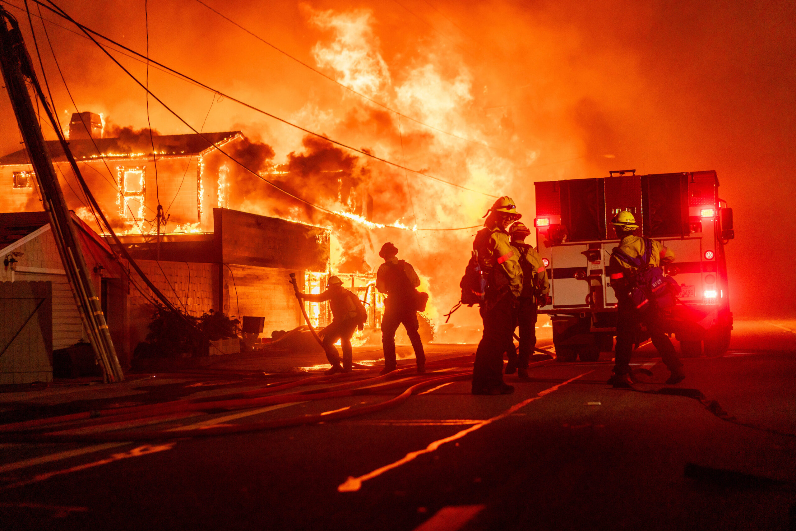 Firefighters battle flames during the Palisades Fire in the Pacific Palisades neighborhood of Los Angeles