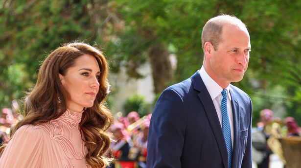 Prince William and Princess Kate walking side by side as they arrive for royal wedding in Jordan