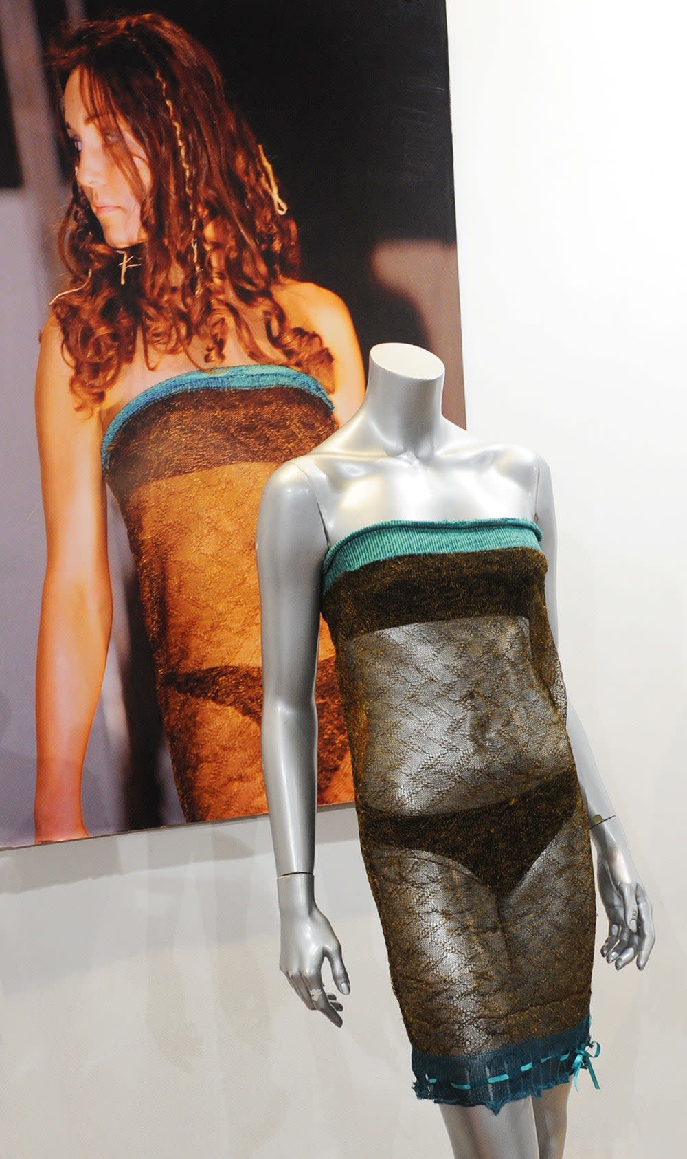 A mannequin wearing Kate Middleton's runway fashion next to a photo of her.