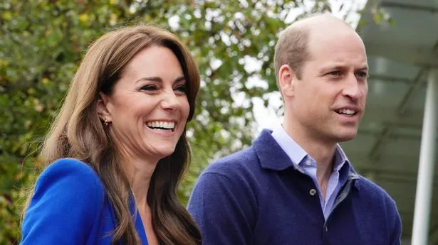 Prince William and Kate Middleton stood side by side and smiling