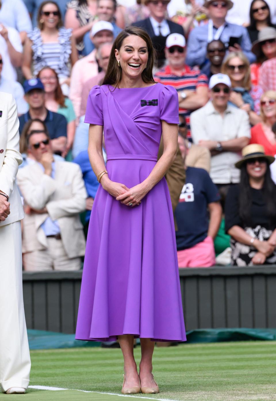 Kate Middleton stands in a purple dress at Wimbledon 2024.