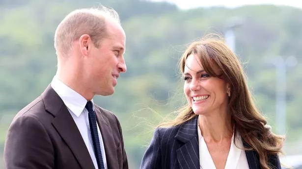 Prince William and Kate Middleton look at each other, smiling