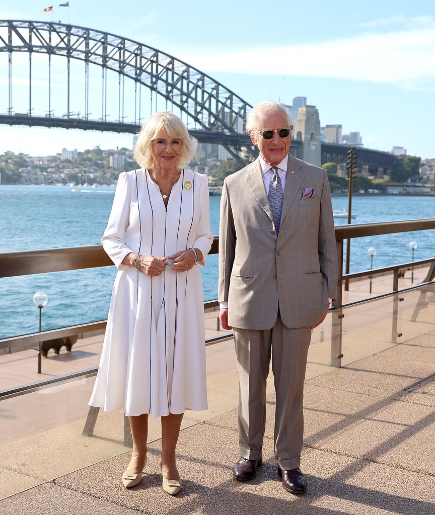 King Charles III and Queen Camilla pose for a photo in front of Sydney Harbour Bridge