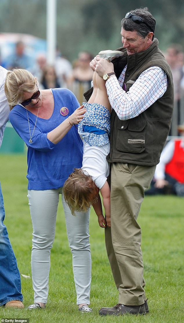 Sir Timothy Laurence holding Mia upside down at the Badminton Horse Trials in 2016