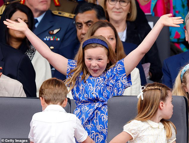 Mia smiling, with Prince Louis and Princess Charlotte sitting in front of her, at the late Queen's Platinum Jubilee Pageant in 2022