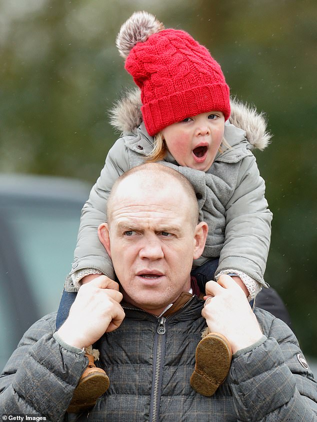 Mia, just two years old at the time, yawning as her father carries her on his shoulders in 2016