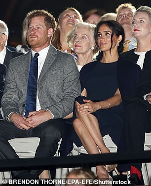 Wearing a navy Stella McCartney cape dress at the Invictus Games opening ceremony in 2018