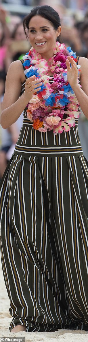 A pregnant Meghan appeared barefoot in this Martin Grant dress on Bondi Beach in 2018