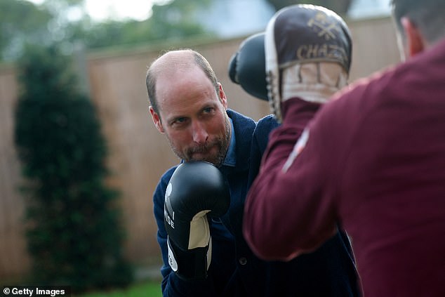 Put 'em up! Concentrating hard, the prince sparred with one of the trainers during the boxing session