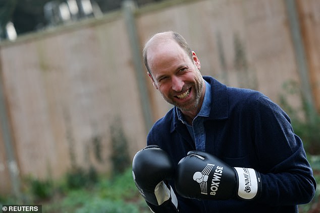 Prince William wears a pair of boxing gloves during his visit to Centrepoint, a charity which supports homeless youth, in west London on Tuesday