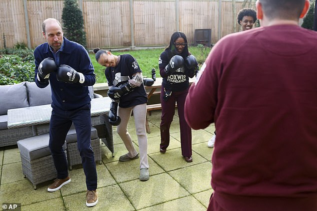 Taking it seriously: the royal looked like he was up for the fight as he lined up to spar