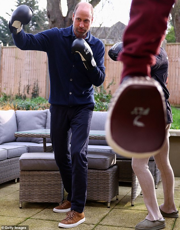 The prince gets some tuition as he practises his boxing moves