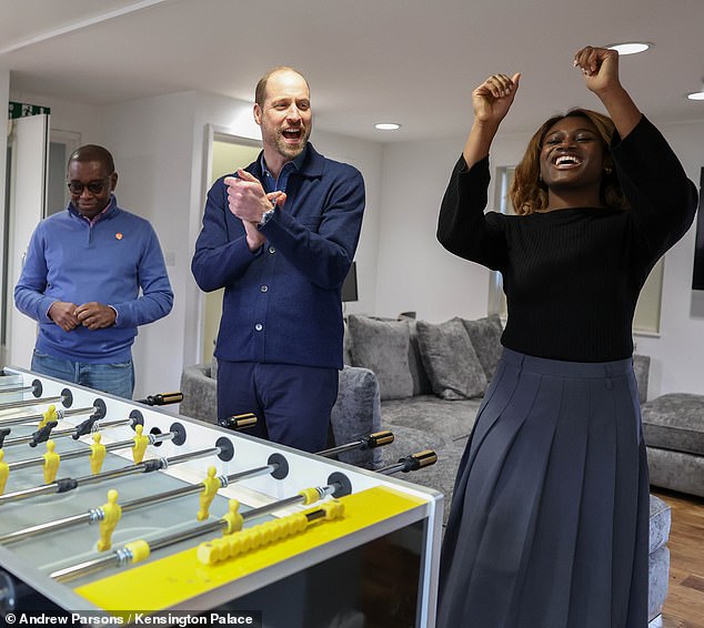 The heir to the throne, dressed down in a blue cardigan and chinos, indulged in a game of table football