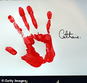 Kate recreated the artwork using bright red paint seven years later