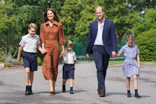 Prince George, Princess Charlotte and Prince Louis (C), accompanied by their parents the Prince William, Duke of Cambridge and Catherine, Duchess of Cambridge, arrive for a settling in afternoon at Lambrook School