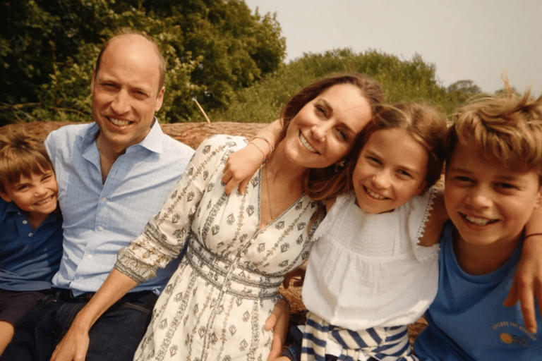 William and Kate smiling with their children, Louis, Charlotte and George. 