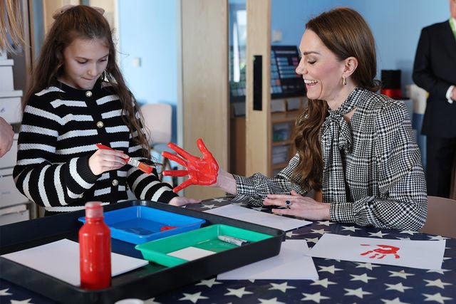 Richard Pohle - WPA Pool/Getty Catherine, Princess of Wales has her hand painted by 9 year old Lottie whose sibling is being treated at the Ty Hafan, children's hospice based in Sully, near Cardiff, which supports families in Wales to ensure that children with life-shortening conditions live fulfilling lives, supported with the compassion and specialist care that they and their family need on Jan. 30, 2025 in Sully, Wales