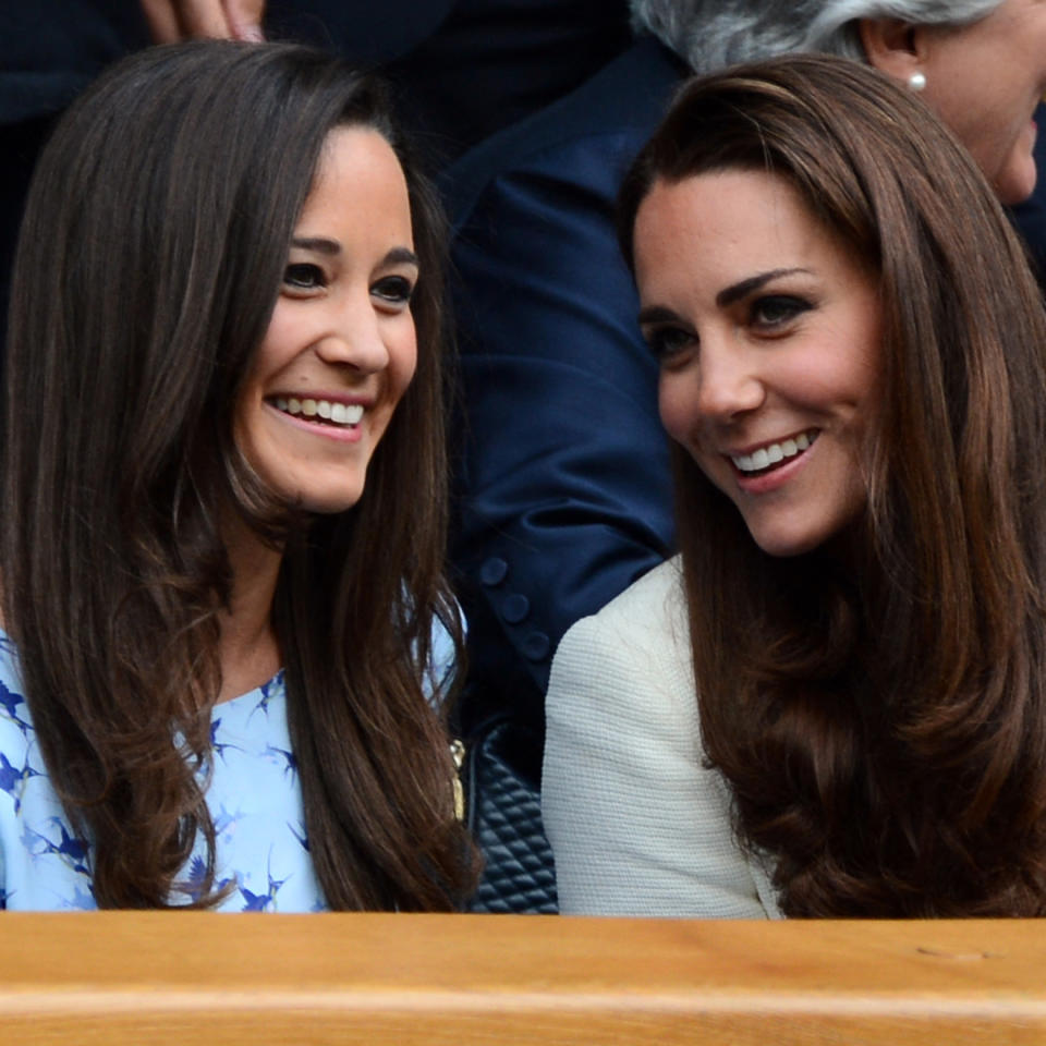  Pippa and Kate Middleton smile and both have long brown hair as they attend Wimbledon in 2012. 