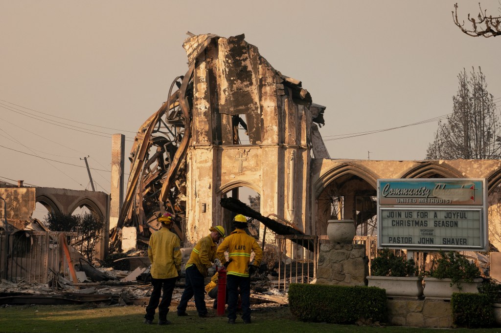 Firefighters work near a church destroyed in the Palisades Fire.