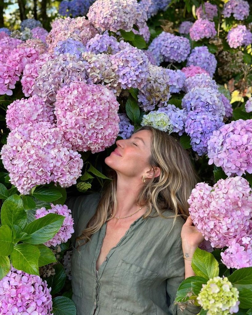 Gisele Bündchen smelling flowers.