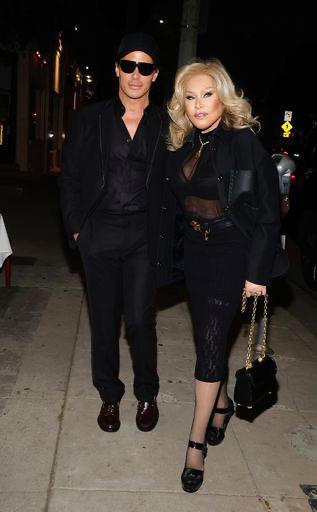 Jocelyn Wildenstein, dressed in black, with Lloyd Klein, wearing sunglasses.