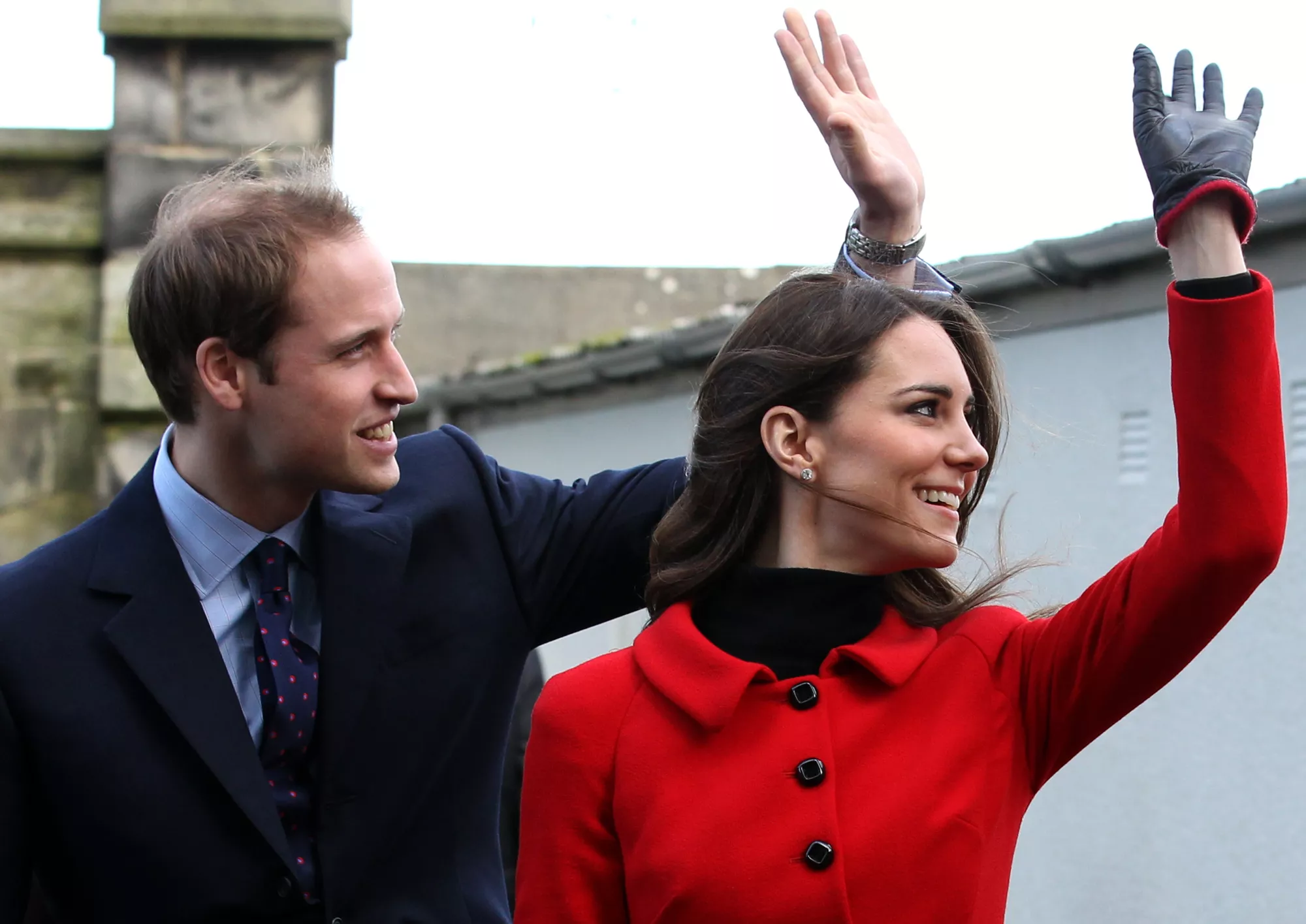 Prince William (L) and his fiancee Kate Middleton wave as they pass St Salvator's halls during a visit to the University of St Andrews in Scotland on February 25, 2011. During the visit they viewed the surviving Papal Bull (the university's founding document), unveiled a plaque, and met a selection of the Universitys current staff and students to mark the start of the Anniversary. Prince William and Kate Middleton attended the university as students from 2001 to 2005 and began their romance in St Andrews.2011