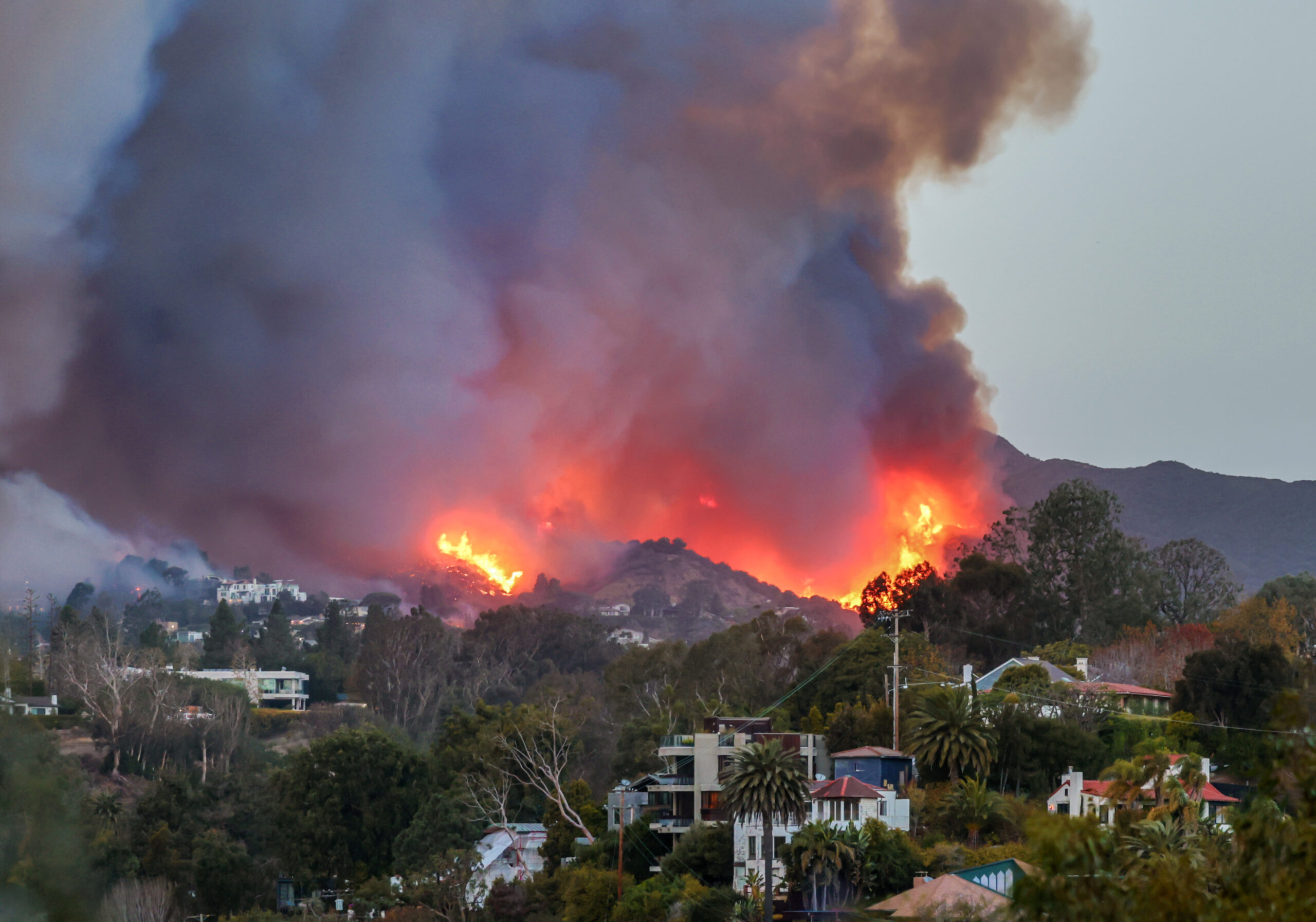 Smoke and flames from the Palisades Fire fill the sky