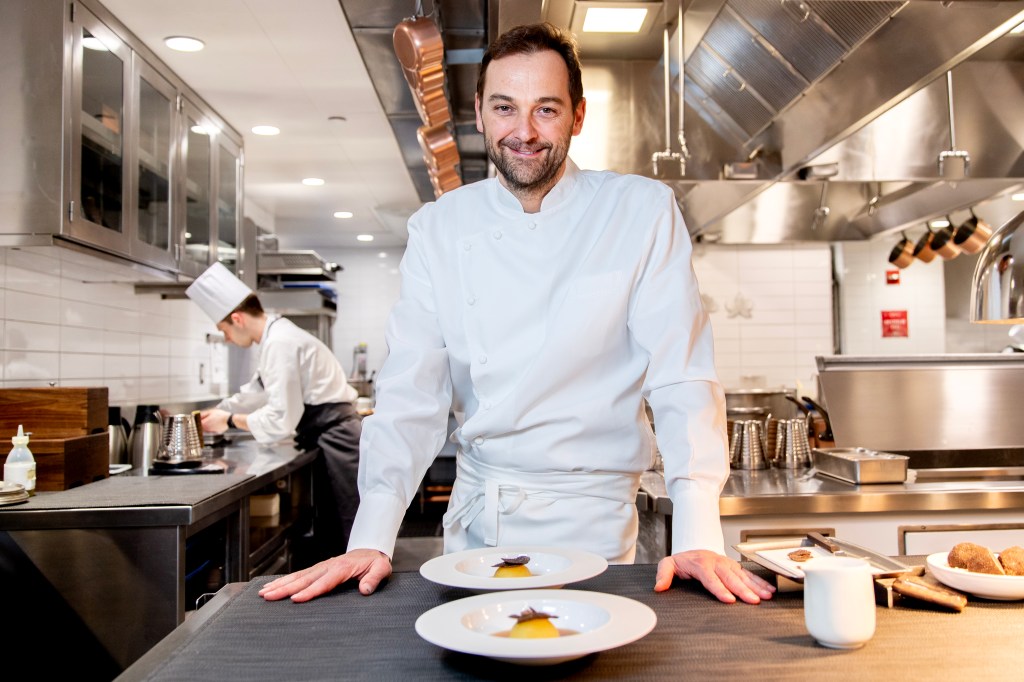 Chef Daniel Humm prepares Potato with Black Truffle and Smoked Potato Consommé in the kitchen at Eleven Madison Park.
